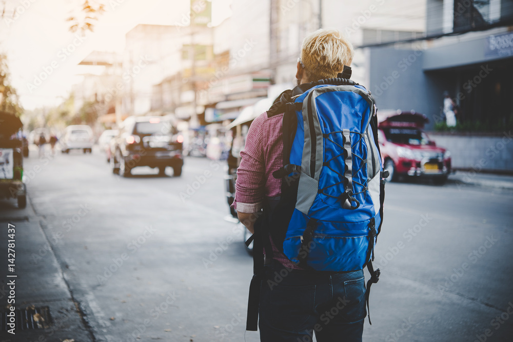 Young traveler hipster with backpack travel. Adventure tourism concept.