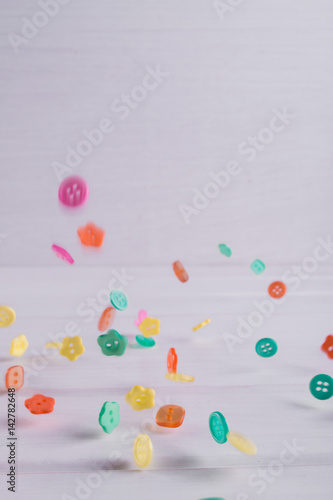 Falling Colourful sewing buttons on white background