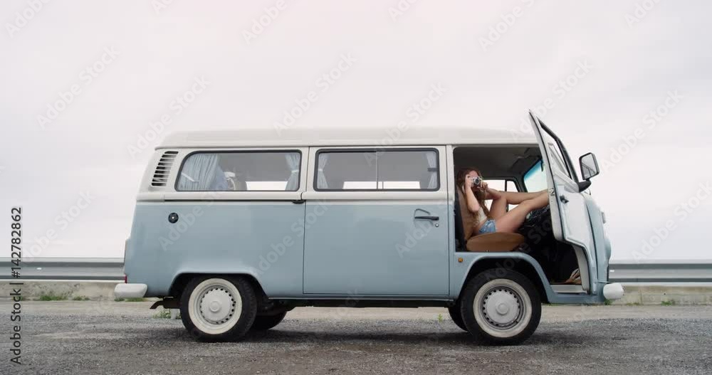 Portrait Beautiful hippie girl taking photos with retro digital camera road trip camper van Portrait Beautiful hippie girl taking photos with retro digital camera road trip camper van