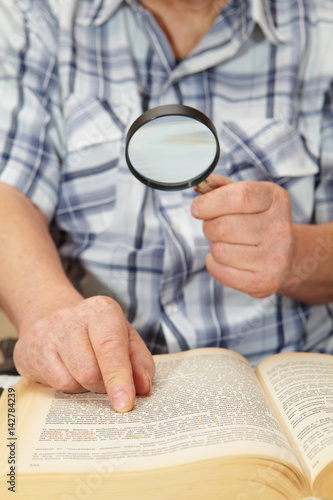 Elderly man reading a book