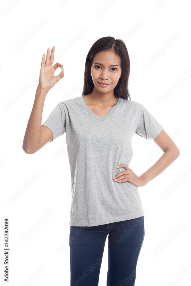 Young Asian woman show OK sign.