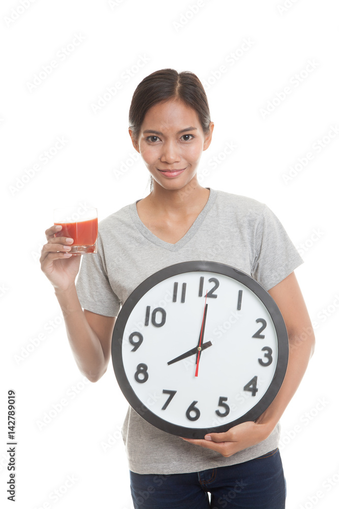 Young Asian woman with tomato juice and clock.