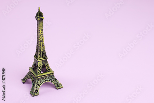 Souvenir Eiffel Tower on pink paper background. © ilovewinter