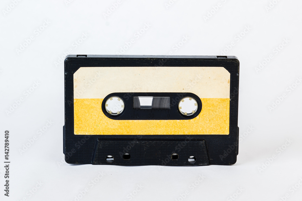Old audio cassette isolated on white background. Historical records sound on a magnetic tape. Place for your text.