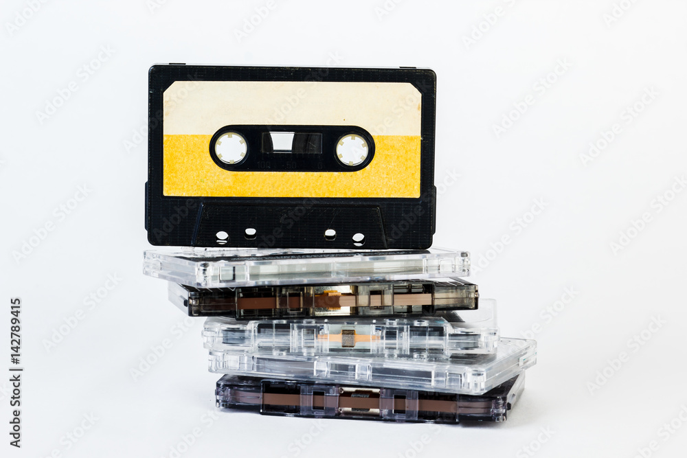 Old audio cassette isolated on white background. Historical records sound on a magnetic tape. Place for your text. Old audio cassette isolated on white background. Historical records sound on a magnetic tape. Place for your text.