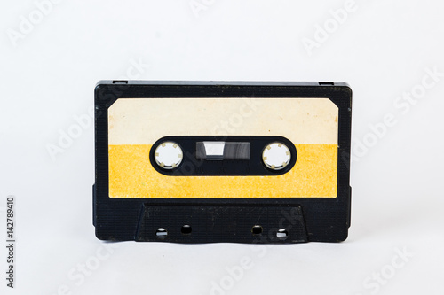 Old audio cassette isolated on white background. Historical records sound on a magnetic tape. Place for your text.