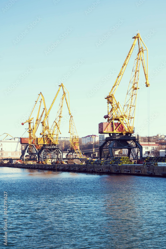 Port cargo crane over blue sky background. Sea port, crane for loading at sunset. Transportation Port cargo crane over blue sky background. Sea port, crane for loading at sunset. Transportation