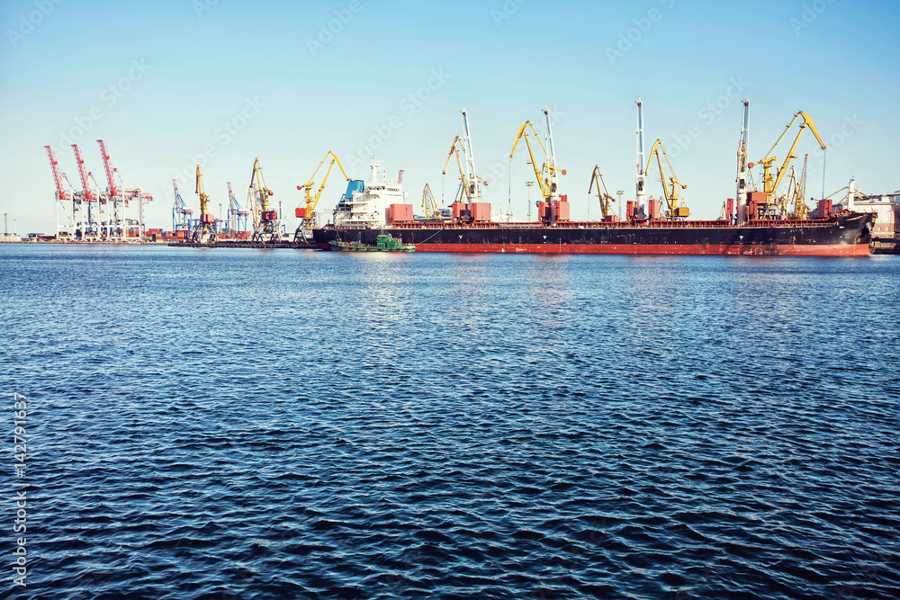 Port cargo crane over blue sky background. Sea port, crane for loading at sunset. Transportation Port cargo crane over blue sky background. Sea port, crane for loading at sunset. Transportation