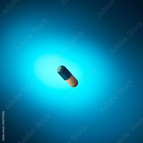 pill floating above the blue background