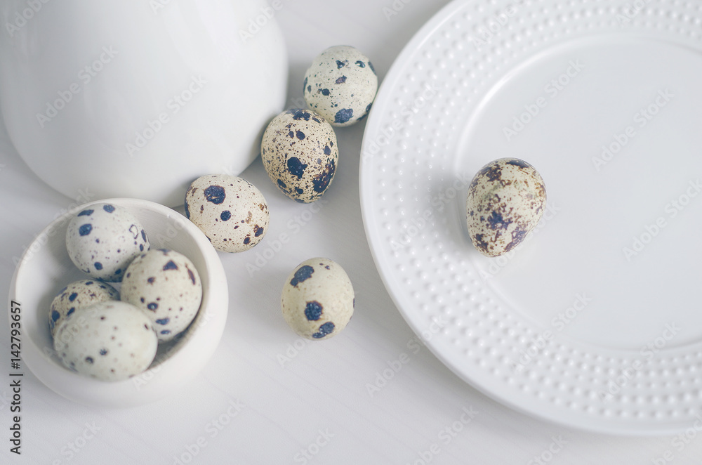 Table setting with empty white plate and quail eggs. Prepare to Easter. Toned in cold scale