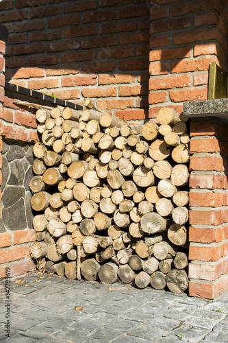 firewood stacked under the stone wall