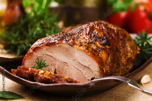 Roast pork with herbs and vegetables. photo