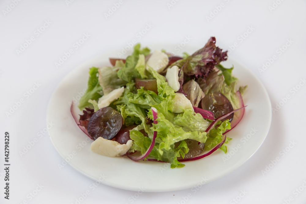 Dietary salad., Grapes, cheese, onions Lettuce. Plate isolated on white background Dietary salad., Grapes, cheese, onions Lettuce. Plate isolated on white background