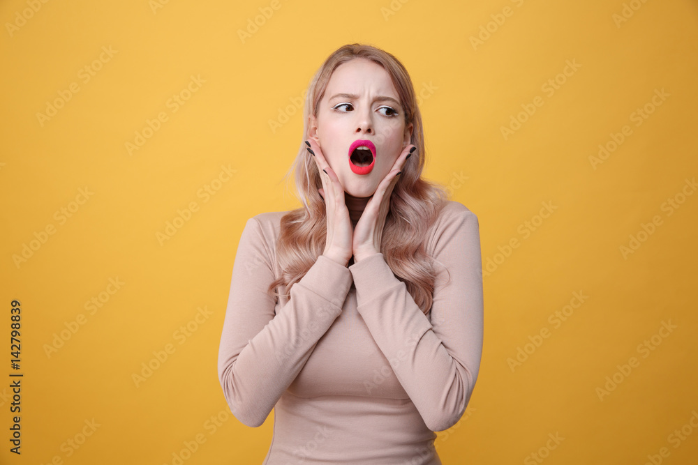 Shocked young blonde lady with bright makeup lips Shocked young blonde lady with bright makeup lips