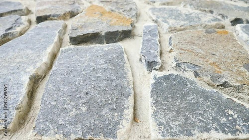 Building wall built from broken flat stones. Old stony wall from nature material and concrete, broken marl stones , traditional building materials. 