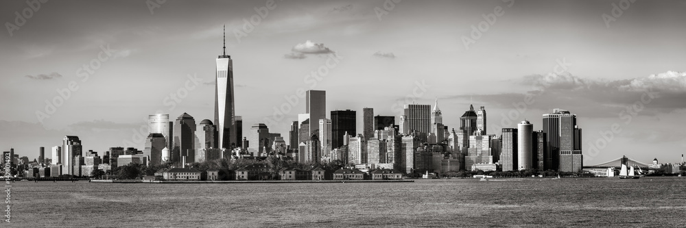 Lower Manhattan with the Financial District skyscrapers and Ellis Island. Panoramic view of New York City. Black & White