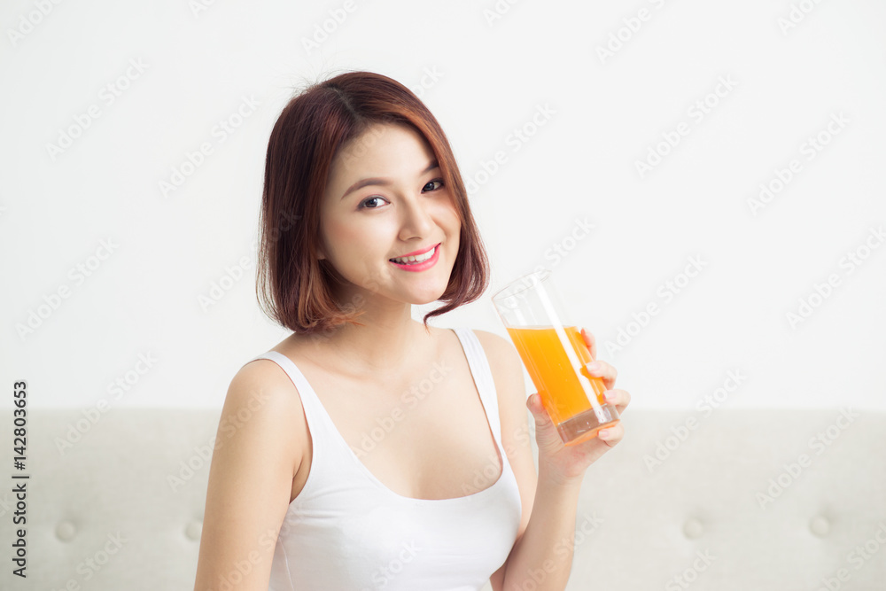 Portrait of a beautiful young asian woman having orange juice. Portrait of a beautiful young asian woman having orange juice.