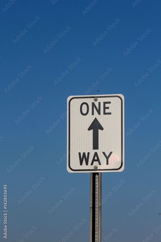A one way sign aiming up to the sky. A one way sign aiming up to the sky.