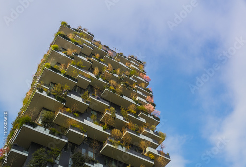 Modern Eco Building And Fast Clouds in Spring with Pink Cherry Trees