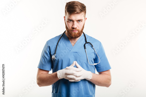 Portrait of a serious concentrated male medical doctor or nurse