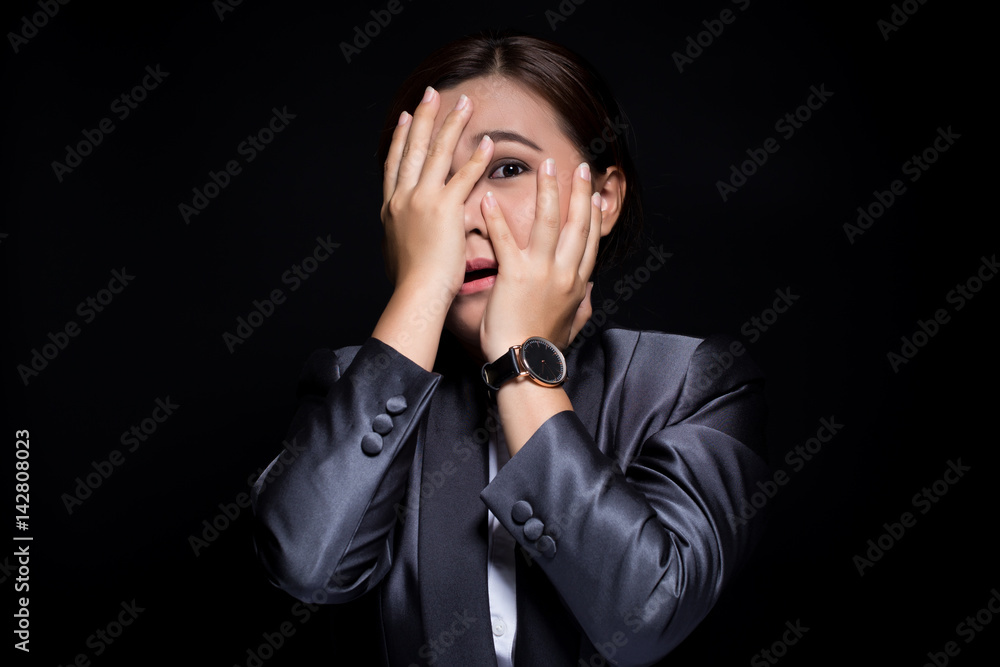 Businesswoman feel scared on isolated black background Businesswoman feel scared on isolated black background