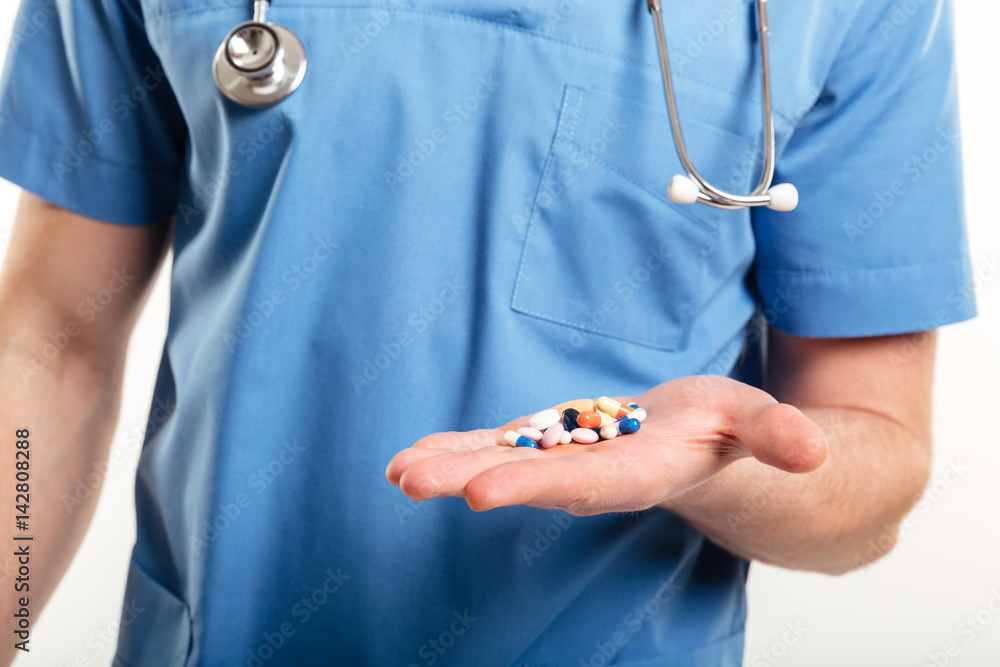 Cropped image of a male doctors palm with pills Cropped image of a male doctors palm with pills