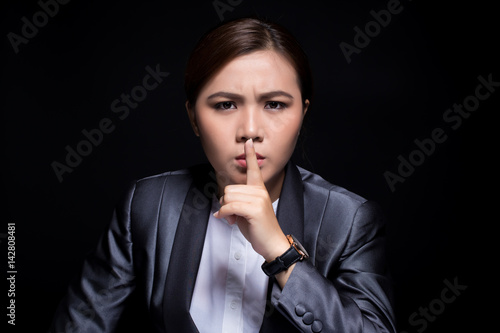 Woman make be quiet gesture