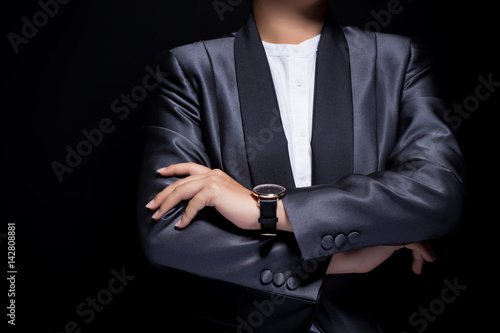 Woman wearing business suit with arms crossed