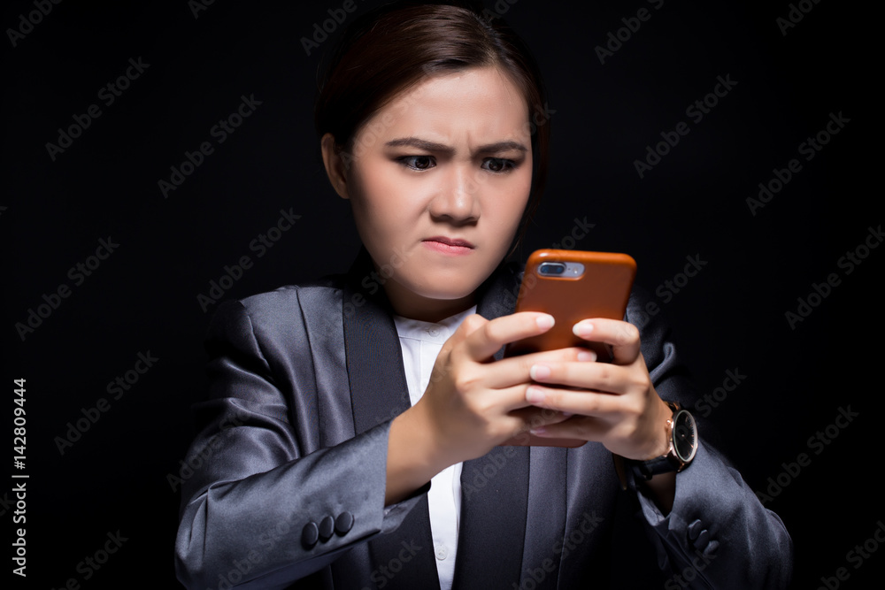 Fototapeta premium Woman use the smartphone and she feel angry