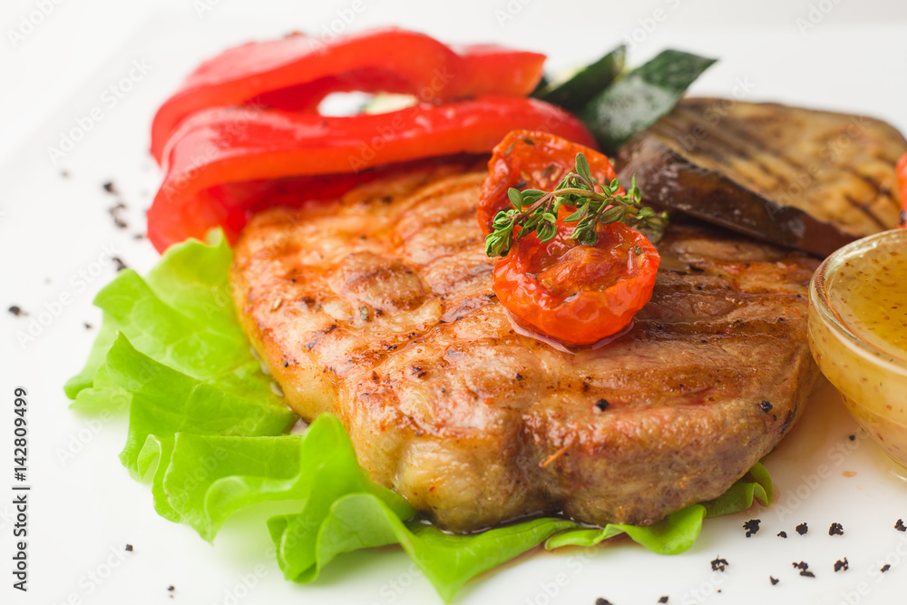 juicy grilled pork with vegetables on a white background, isolated juicy grilled pork with vegetables on a white background, isolated