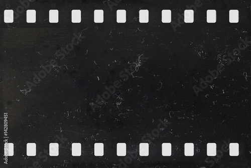 Strip of old negative celluloid film with dust and scratches