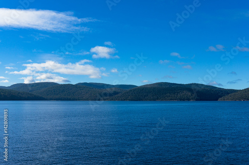 Ocean landscape with forest mountains in the distance