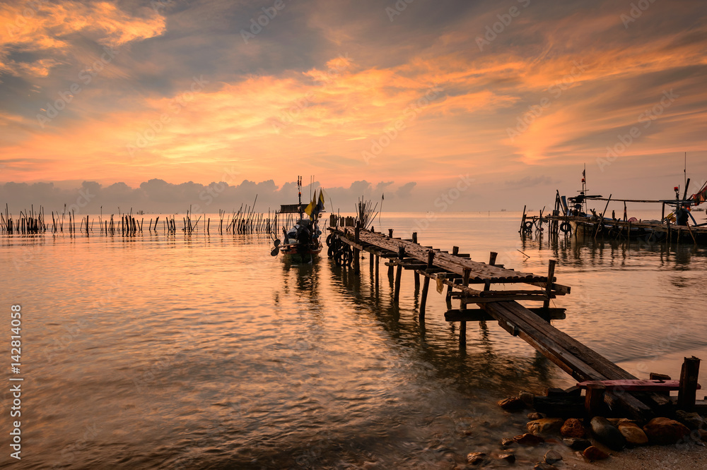 Sunrise on beach and boat fisherman,Thailand