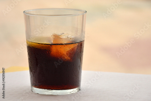 Cold refreshing drink. Cola with ice.