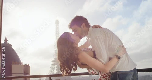 Romantic couple in Paris Eiffel Tower embrace kissing honeymoon enjoying European summer holiday travel vacation adventure photo