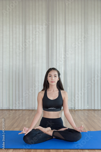 beautiful woman practicing yoga and gymnastic on blue mat. Helth concept.