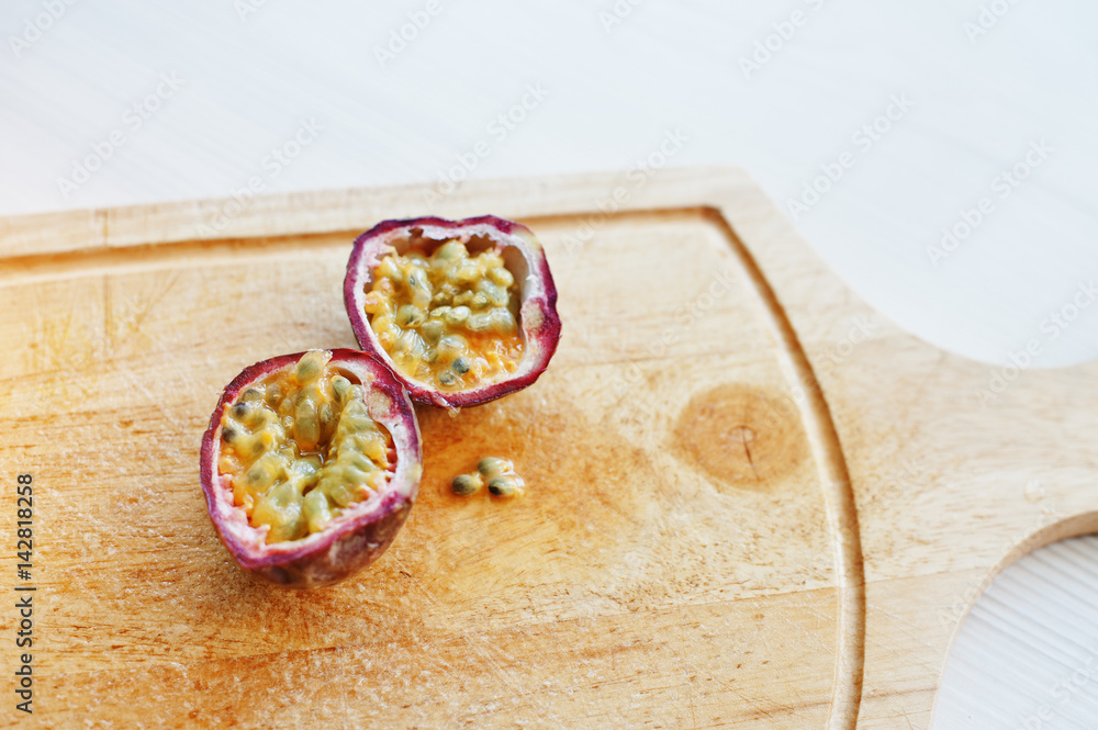 Exotic fruits passion fruit or maracuya (Passiflora edulis) on wooden board. Healthy eating dieting food. Exotic fruits passion fruit or maracuya (Passiflora edulis) on wooden board. Healthy eating dieting food.