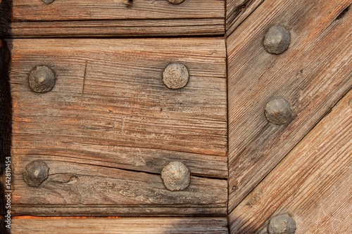 Old wooden boards with nails. Place for text. The wooden door of the castle.