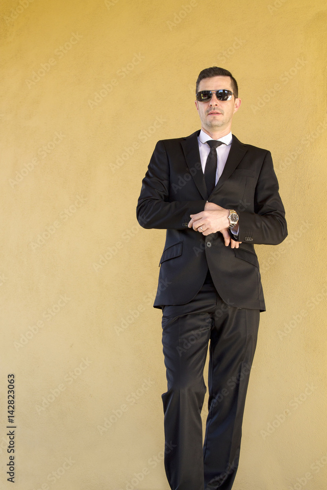 Man tying the suit button Man tying the suit button