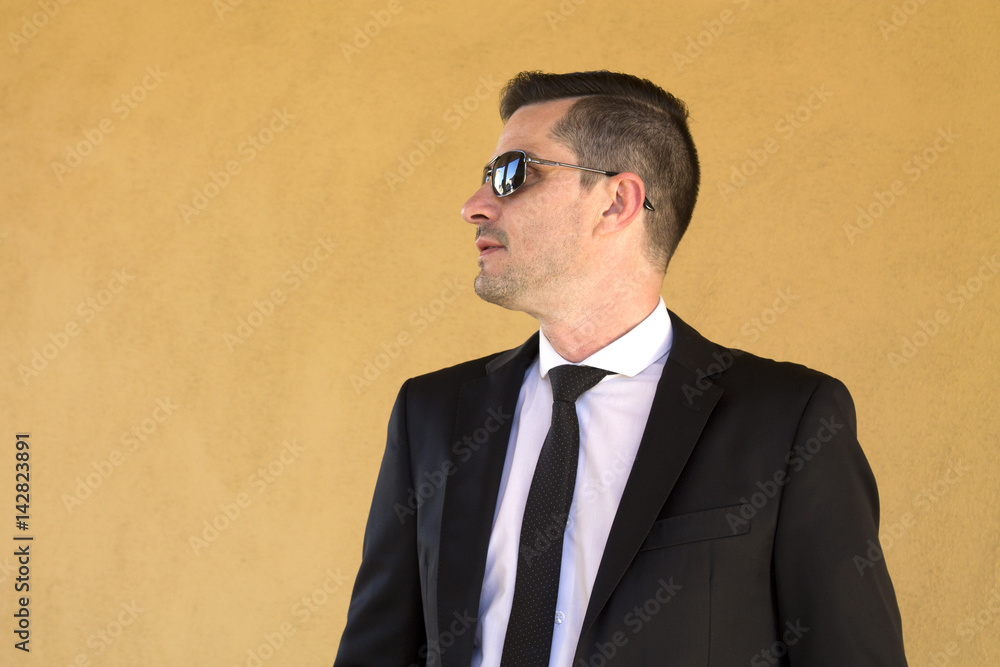 Portrait of man in suit and sunglasses Portrait of man in suit and sunglasses
