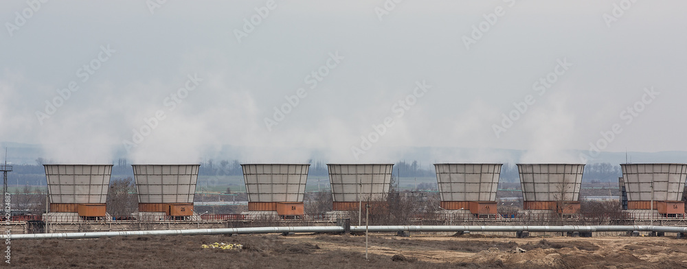 Fototapeta premium Smoking industrial chimneys.Heating pipes
