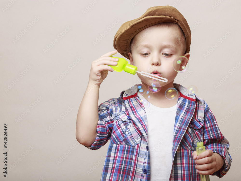 Little cute boy is blowing soap banks Little cute boy is blowing soap banks