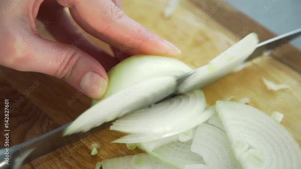 Chef cuts onion for making vegan meal, vegetables for fresh salad, spicy food Chef cuts onion for making vegan meal, vegetables for fresh salad, spicy food