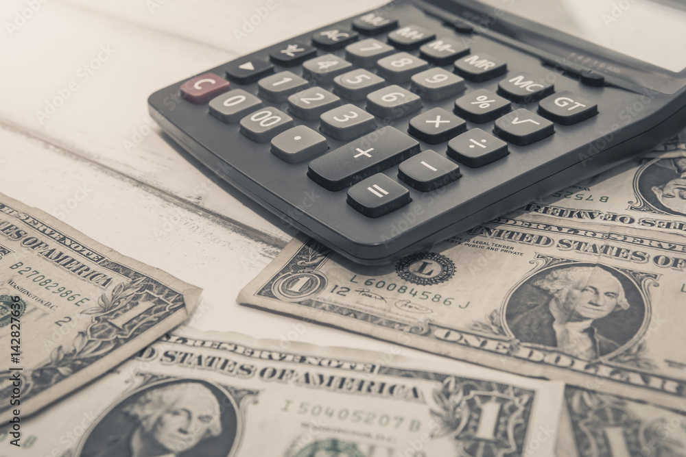 Calculator with american dollars on the wooden table background, finance concept, pencil, phone Calculator with american dollars on the wooden table background, finance concept, pencil, phone