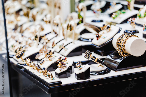 Set of luxury jewelry with precious gems and stones on a showcase of a shop