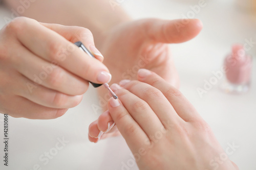 Young woman getting manicure in spa salon  closeup