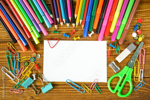 blank paper sheet with pencils and scissors photo