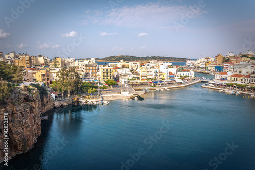 The lake Voulismeni in Agios Nikolaos, a picturesque coastal town with colorful buildings around the port in the eastern part of the island Crete, Greece