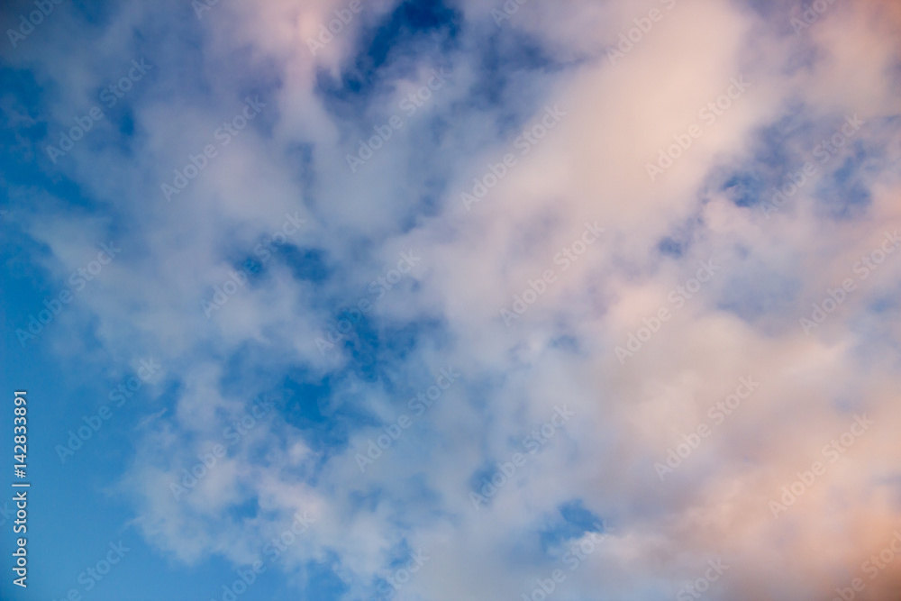 White pink fluffy clouds on blue sky