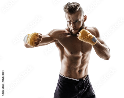 The boxer is ready to deal a powerful blow. Photo of muscular man isolated on white background. Strength and motivation.